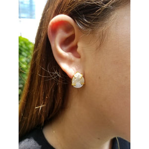 Woman with handmade mother-of-pearl earrings