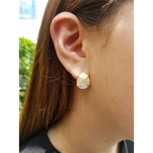 Woman with silver and mother-of-pearl earrings